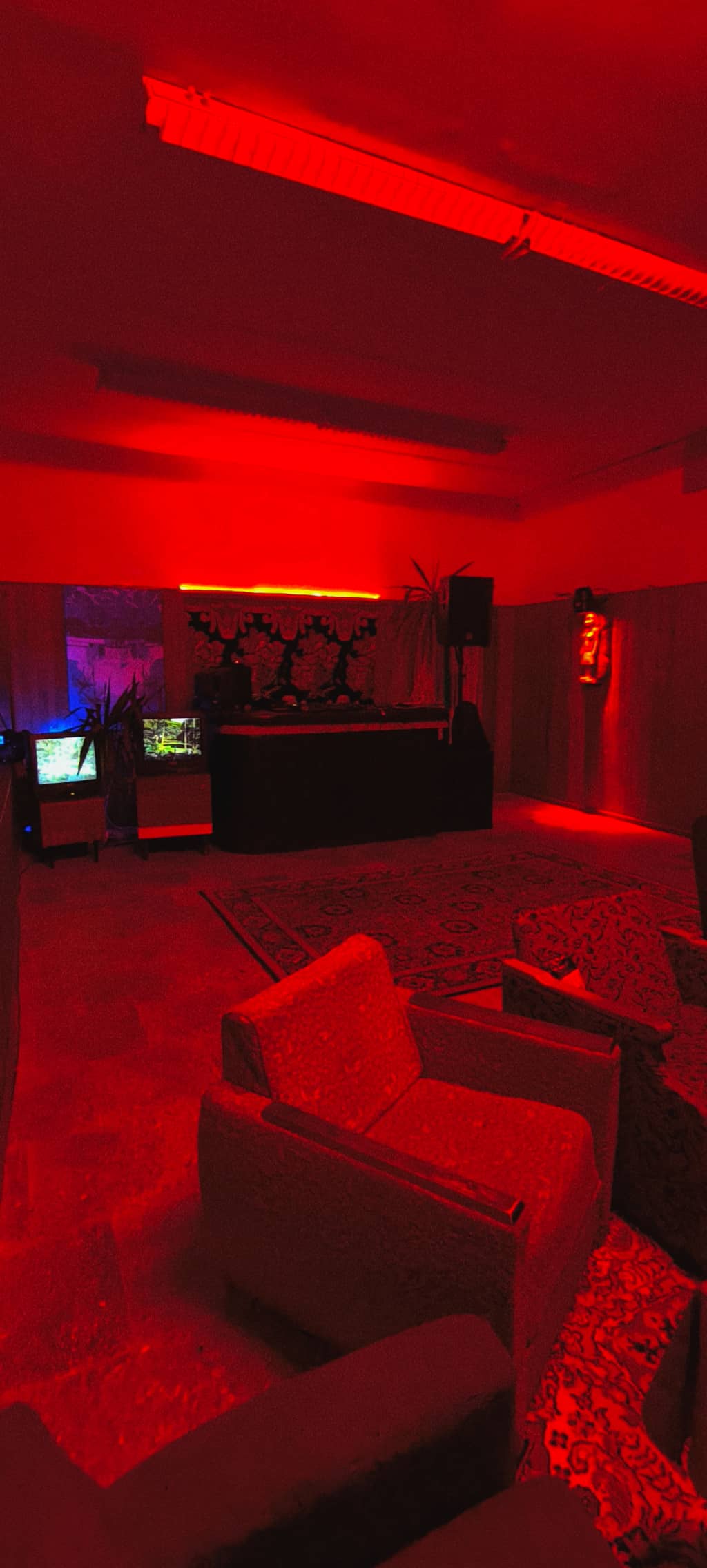 Main Stage Dance floor lit in RED light, super fancy carpet in the middle