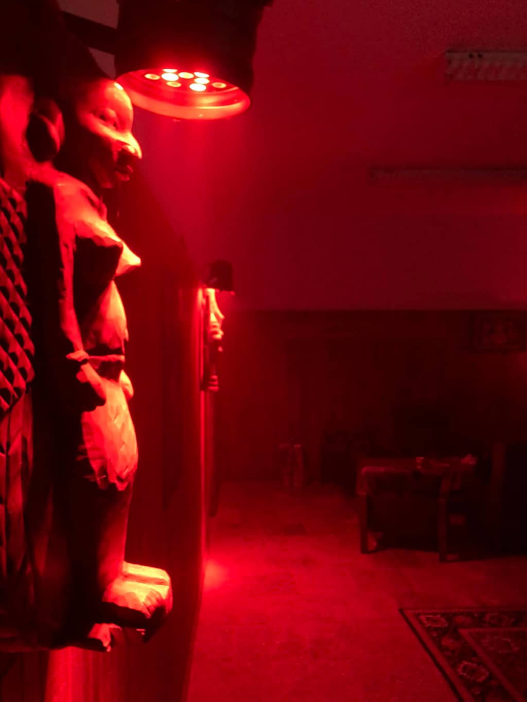 Totem Statues Wooden Totems hanging from the ceiling, RED light