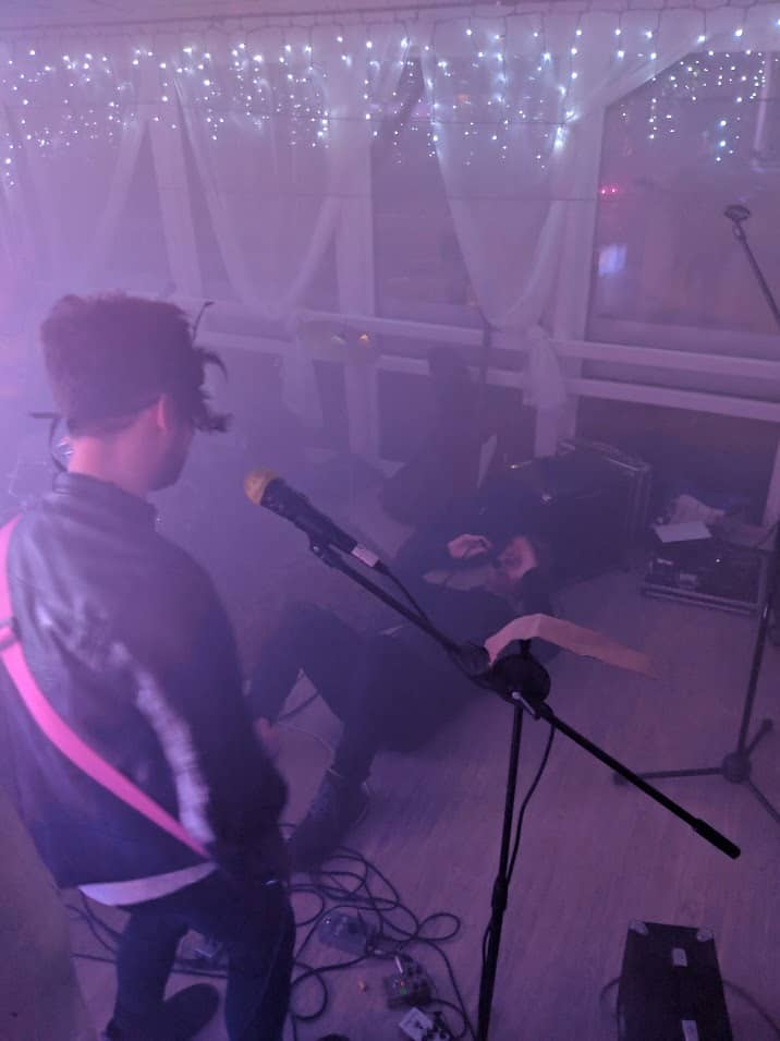 Molded Carpet Band performing live, lead singer doing a thing on the floor