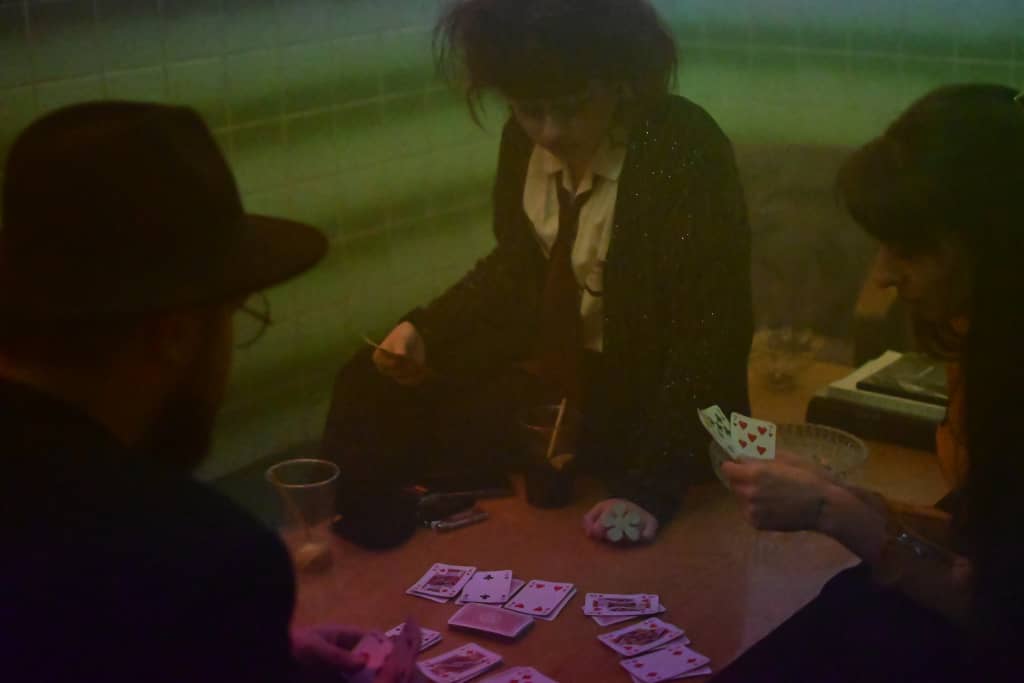 Devils Game People playing cards in the pool