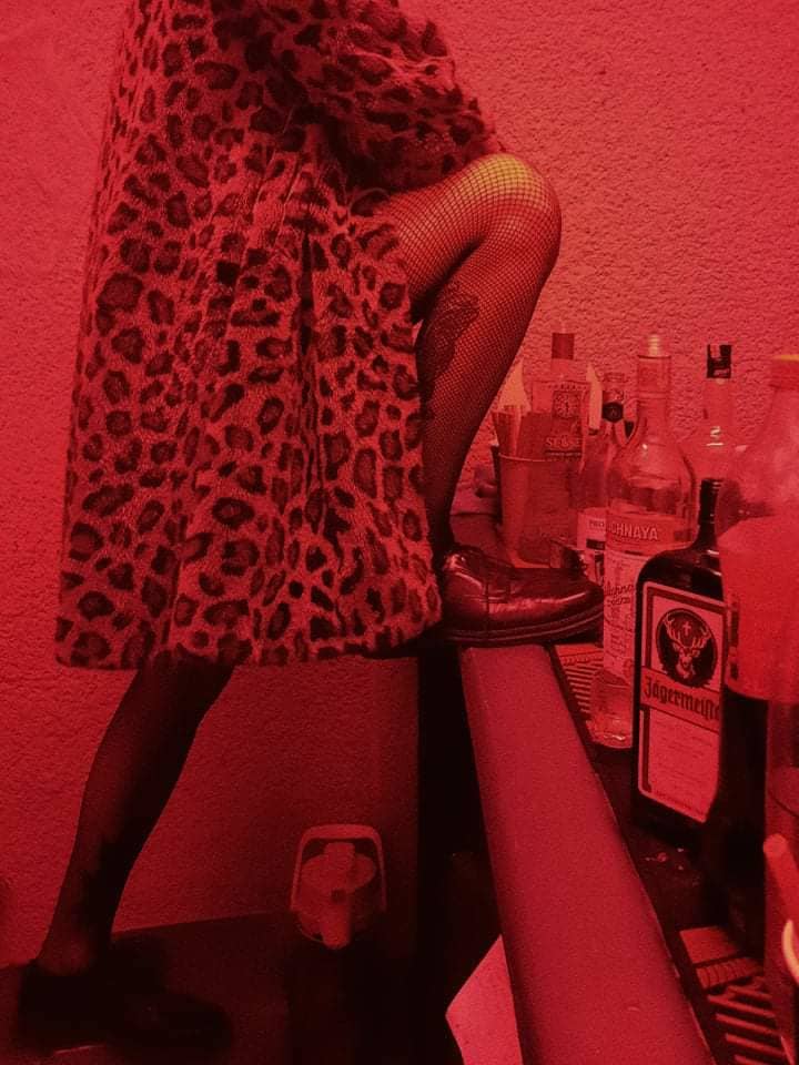 Hot Person next to the bar with one leg on the table-top