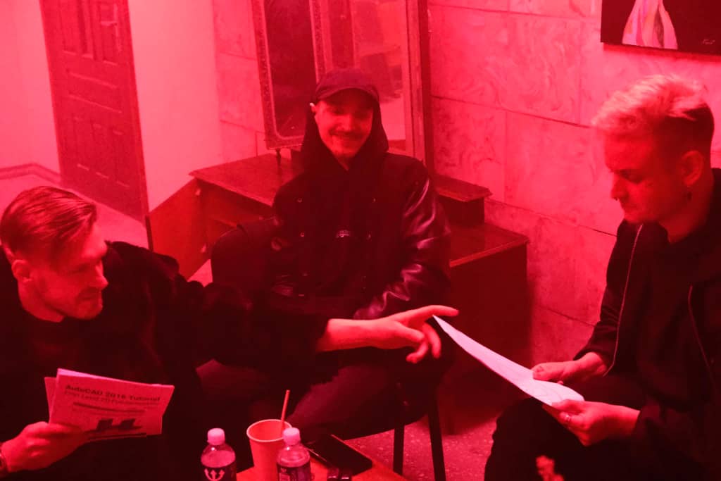 Autocad lesson Three guys sitting and discussing Autocad learning material