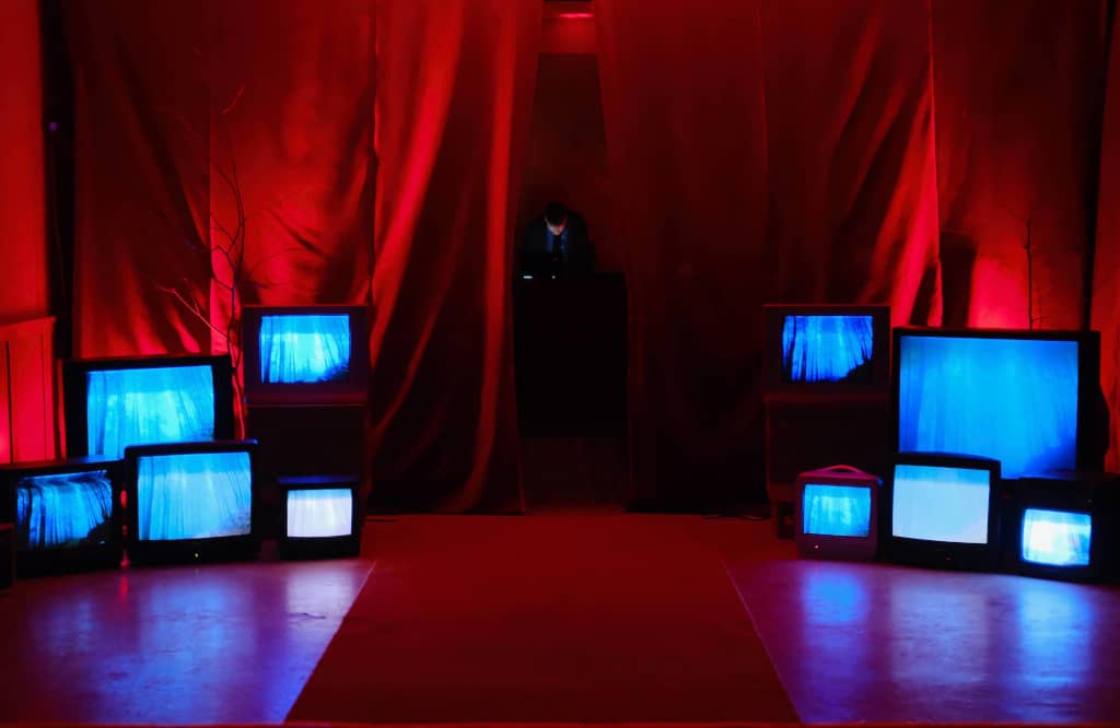 Entrance to the main stage Red curtains on left and right, with TVs placed in front revealing the main stage