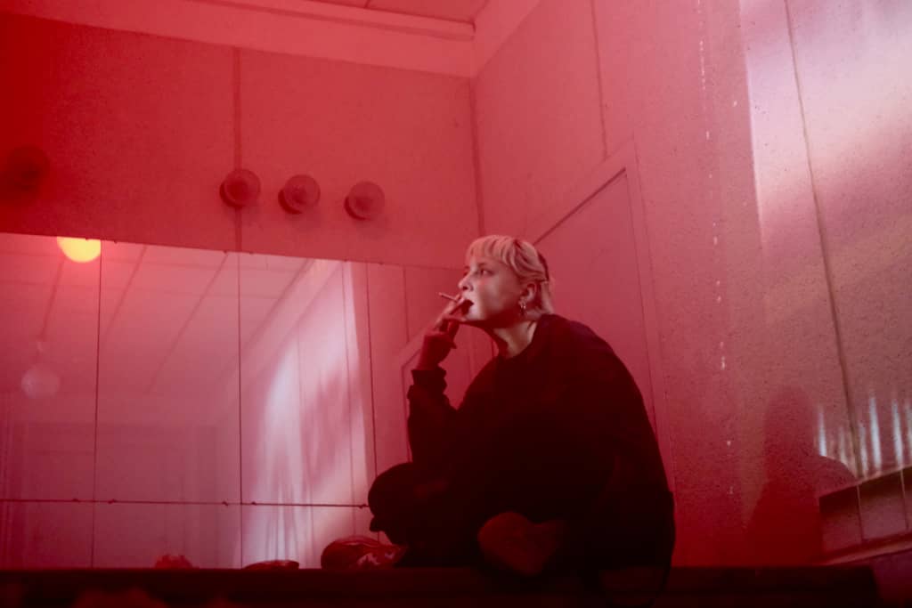 Ashing in Pool Room A person smoking a cig next to a mirror array