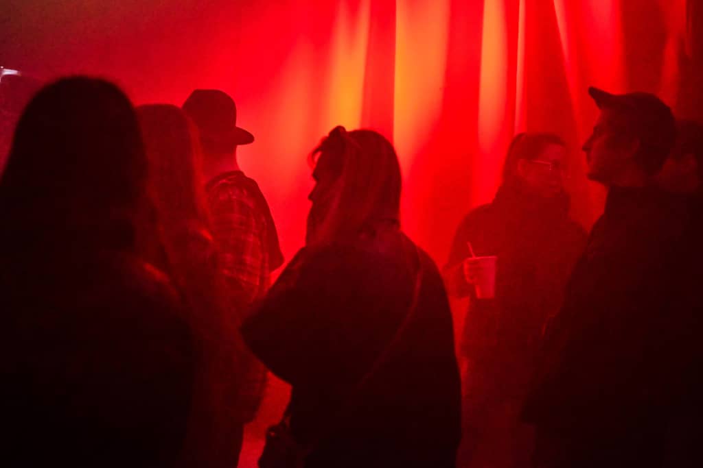 Dance floor Dance floor filled with people, red color with lots smoke