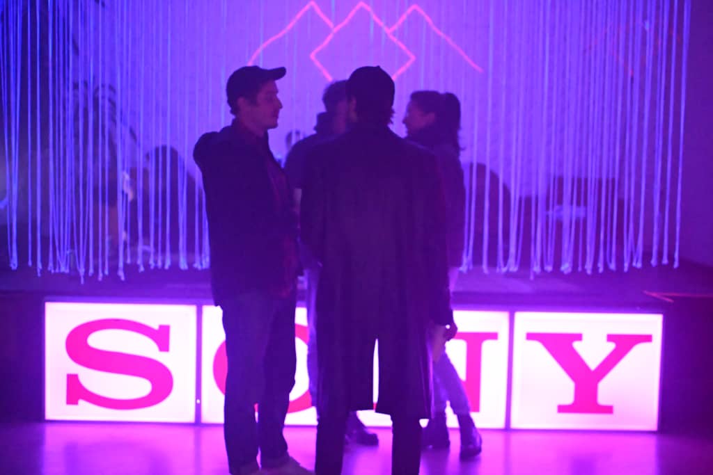 SONY SONY sign and a bunch of people standing in front of it