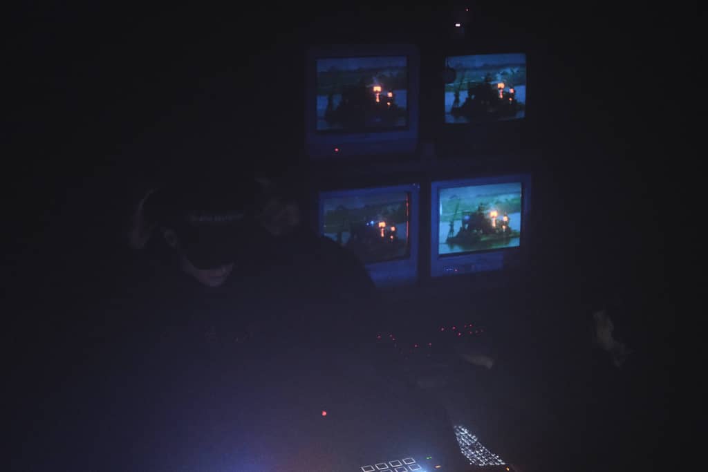 TVs Dark photo of DJ with TVs in the background