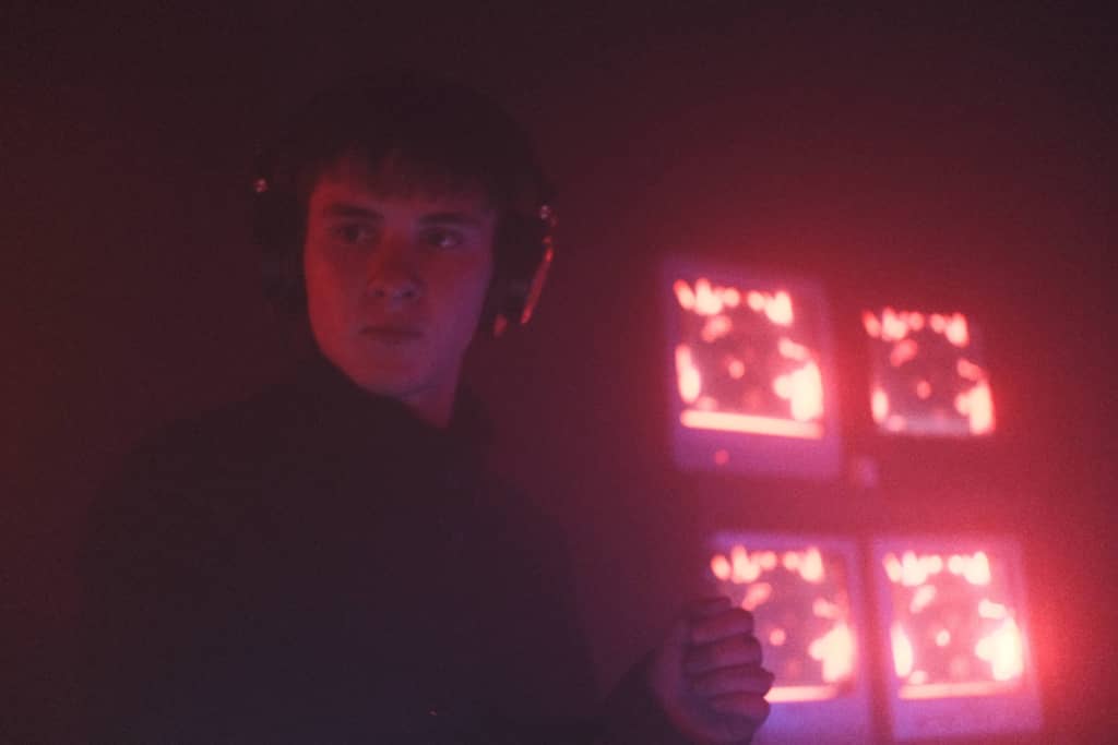 Yugiasha DJ with TVs visible in the background, RED